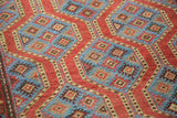 Madder red channels and indigo blue geometric motifs on a vintage Northwest Persian rug.