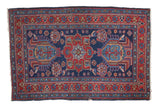 Distressed Heriz rug, deep indigo and cherry red geometric star medallion.