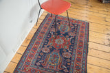 Distressed Heriz rug, rich indigo and cherry red with worn star and leaf borders.