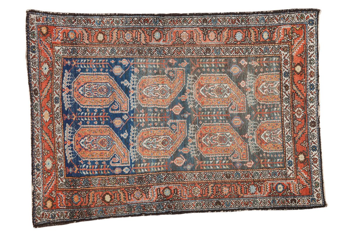 Vintage Persian Malayer rug featuring oversized paisley boteh, abrash blue field, and madder borders, 4x5'7.