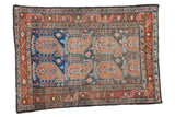Vintage Persian Malayer rug featuring oversized paisley boteh, abrash blue field, and madder borders, 4x5'7.