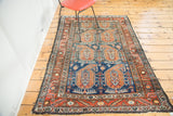 Vintage Malayer rug corner, with softened madder root border and saffron paisley on navy field.