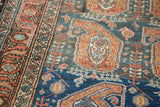 Softened madder root border, charcoal field with abrash, and paisley boteh on Malayer rug.