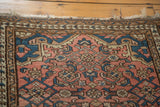 Vintage distressed Malayer rug's dusty rose herati motif, blue accents, and tattered fringe.