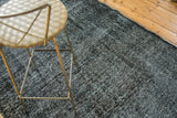 Distressed, mottled dark and faded grey pile of a vintage Turkish overdyed runner.