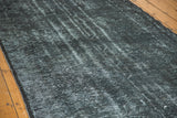 Acid wash dark overdyed pile on vintage Turkish runner, revealing faded patterns and texture.