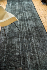 Vintage overdyed Turkish runner with faded black and gray grunge texture.