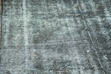 Distressed pile of vintage overdyed gallery runner in faded charcoal and pale gray.