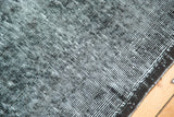 Overdyed vintage rug texture: distressed black and faded blue with dark selvedge.