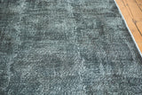Distressed charcoal gray vintage Turkish runner with unique acid wash texture.