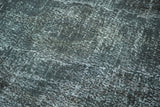 Dark, acid wash distressed texture on a vintage overdyed gallery runner rug.