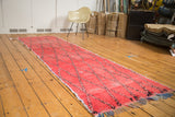 Textured Moroccan distressed runner, faded cinnabar red, navy diagonal lattice, rag rug pile.