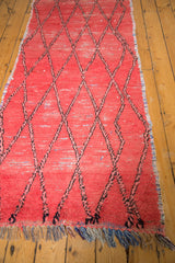 Distressed Moroccan runner with textured rag rug weave and colorful fringe.