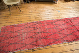 Faded cinnabar red Moroccan runner with distressed rag construction and diagonal lattice.