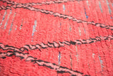 Distressed cinnabar red Moroccan runner's rag rug weave with navy flecks and diagonal lines.