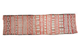 Embroidered Moroccan jijim runner with horizontal geometric patterns in cinnabar, ivory, and black.