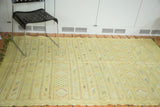 Finely woven lime green Moroccan Kilim rug with intricate striped geometric patterns.