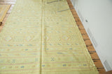 Finely woven lime green Moroccan kilim with striped geometric serpent motifs.