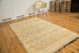 Saffron gold Moroccan Kilim rug with varied geometric bands and fringed ends.