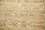 Geometric bands of saffron gold and neutral tones on a Moroccan Kilim rug.