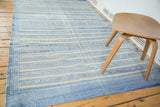 Detail of modern Moroccan kilim with sky blue stripes, geometric guls, and serpent motifs.