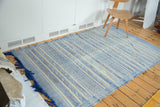 Deep blue fringe and geometric floral motifs on the soft sky blue Moroccan Kilim.