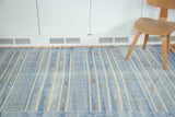 Soft sky blue Moroccan kilim with alternating coloration, finely woven serpent and geometric motifs.