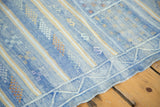 Finely woven sky blue Moroccan kilim edge with embroidered geometric motifs.