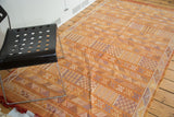 Burnt orange Moroccan Kilim, finely woven with geometric stripes in blue, gold, ivory.