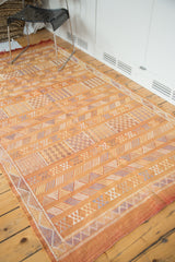 Burnt orange Moroccan kilim, geometric floral guls, faded blue and ivory stripes.
