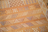 Finely woven Moroccan Kilim detail showing burnt orange ground and geometric floral guls.