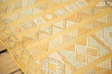 Vibrant saffron yellow kilim detail, showing textured geometric patterns and woven edge.