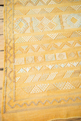Saffron yellow Moroccan kilim showing decorative geometric stripes and subtle sea foam patterns.