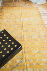 Finely embroidered saffron yellow kilim rug displaying geometric stripes and diamond motifs.
