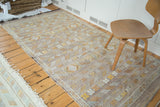 Finely woven geometric designs in gold, ivory, and subtle purple on a New Kilim rug.