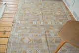 Finely woven modern Moroccan Kilim rug with decorative stripes, geometric guls, and muted tones.