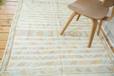 Finely woven Moroccan Kilim rug showing geometric stripes in saffron, terra cotta, blue.