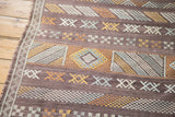 Finely woven geometric patterns in eggplant, gold, silver on a Moroccan kilim.