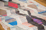 Geometric argyle zigzag pattern with playful multi-color texture on a vintage rag runner.