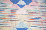 Dense construction vintage Moroccan rag rug, with geometric triangles and colorful stripes.