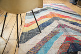 Dense texture of vintage Moroccan rag rug, with recycled cotton and colorful chevron stripes.