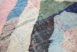 Dense recycled cotton strips form the multi-colored pattern of this vintage rag rug.
