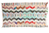 Colorful vintage Moroccan Rag Rug, vivid zigzag pattern in peach, mint, blue, red.