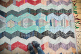 Zigzag motif vintage rag rug with feet, red, ivory, charcoal, mint.