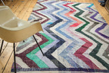 Vintage Moroccan rag rug with dense running zigzag pattern in blue, violet, green, peach.