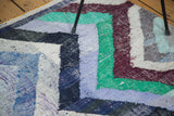 Detail of dense woven recycled cotton rag rug with colorful zigzag pattern.