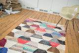 Dense geometric hexagonal pattern of recycled cotton textiles on a vintage Moroccan rag rug.
