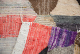 Detailed view of vintage Moroccan rag rug's dense weave and colorful hexagonal motif.