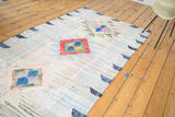 Dense woven texture of vintage rag rug with colorful geometric medallions.