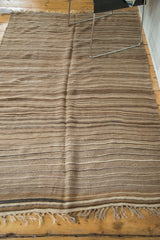 Striated stripes in natural beige, coffee, and brown tones on this Moroccan Kilim.